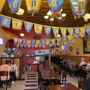 people sitting at tables in a restaurant