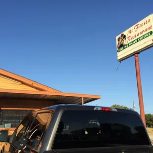 a truck parked in front of a restaurant