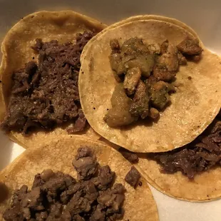 three tacos in a white container