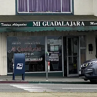 a parking meter in front of a business