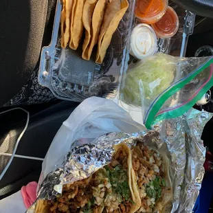 a burrito and chips in a car