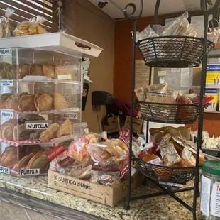 a bakery counter with a variety of baked goods