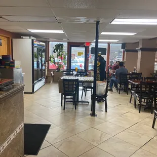 the inside of a restaurant with tables and chairs