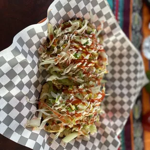 Mixtas - chicken, cabbage, onions, guacamole on tortillas with such a tasty, spicy sauce.