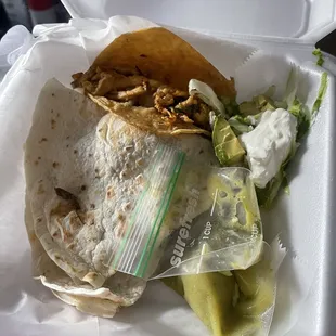 Chicken taco and steak quesadilla.  Quesadilla comes with sour cream, avocado, and lettuce.  Tacos have onions and cilantro.