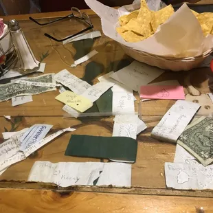 All this trash is UNDERNEATH the glass on our table - not my idea of a decoration &amp; not at all appetizing!