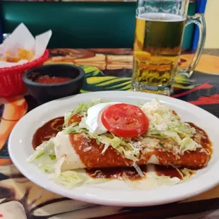 Burritos Deluxe - two chicken and bean burritos, lettuce, sour cream, a tomato slice, grated cheese and a smoky red sauce.