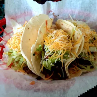 Tacos Grande - marinated steak, lettuce, tomato, cheese and sour cream wrapped in a soft flour tortilla.