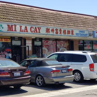 cars parked in front of a restaurant