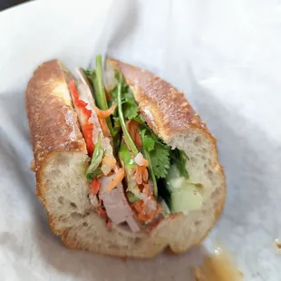 a sub sandwich with meat and vegetables