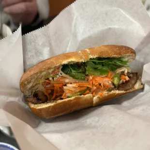 a sub sandwich with carrots and lettuce