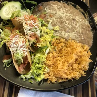 Two chicken tacos. Beans, rice and salad