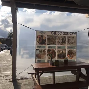 a picnic table with a menu on it