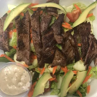 a salad in a styrofoam container