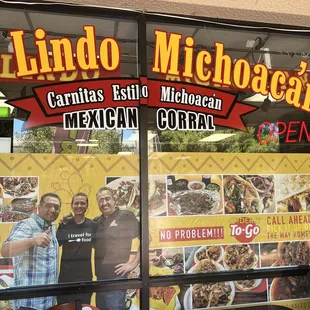 two men standing in front of a mexican restaurant