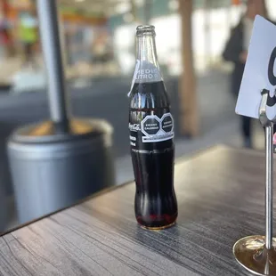 a coke bottle and a table number