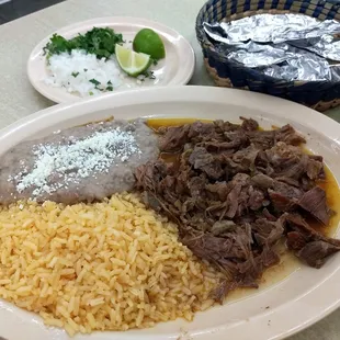 Birria plate. Tender juicy and delicious.The corn tortillas are handmade in house, and very tasty.
