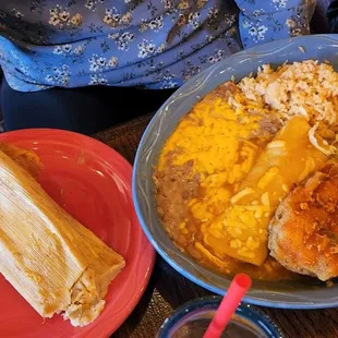 a plate of enchilada and a plate of rice