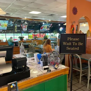 a woman sitting at a counter in a restaurant