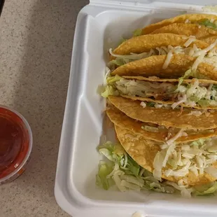 Hard shell chicken tacos and their complimentary salsa.
