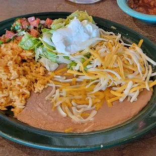 Side plate of rice, beans salsa guacamole and cheese