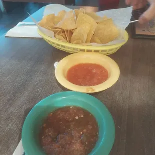 a bowl of chips and a bowl of salsa
