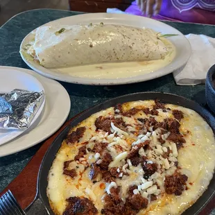 Burrito Loco shredded chicken and cheese on top Was excellent. The appetizer was queso with pork sausage