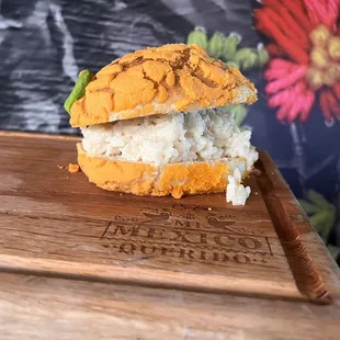 a close up of a sandwich on a cutting board