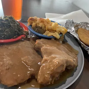 Smothered chops, greens, mac, cornbread, and tea.