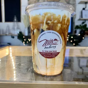 a cup of iced coffee on a table