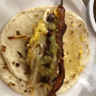 Hash browns with cheese and bacon taco