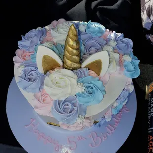 Unicorn cake. White cake...two tiers and strawberries and Bavarian creme inside both layers! I don&apos;t even like cake and YUMMMM