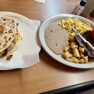 Steak and eggs with a bean and cheese with bacon