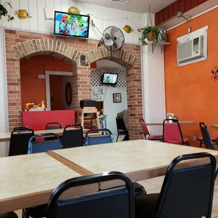 a dining area with tables and chairs
