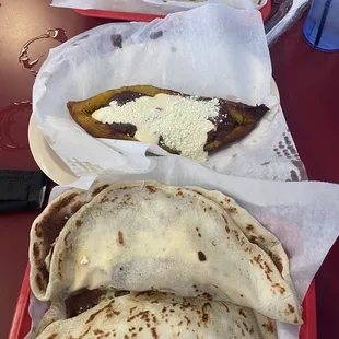 three quesadillas on a red tray