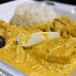 Aji de Gallina ($11.99) - pulled chicken breast, creamy aji amarillo sauce; served with sliced potato, sliced boiled eggs, olives, rice.