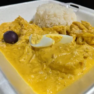 Aji de Gallina ($11.99) - pulled chicken breast, creamy aji amarillo sauce; served with sliced potato, sliced boiled eggs, olives, rice.