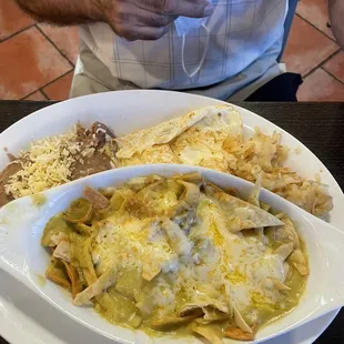 Chilaquiles Verdes with eggs, refried beans and hash browns.