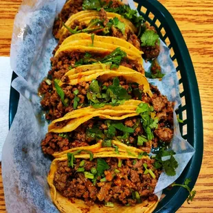 a basket of tacos on a table