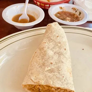 Veggie burrito with tomatillo salsa on the side.