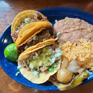 Taco dinner consisting of rice, beans, 3 tacos (tripa, lengua, buche)