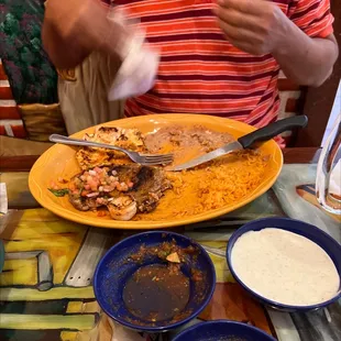 a plate of mexican food with a knife and fork