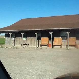 a barn with a horse in front of it