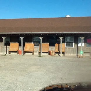 a small building with several chairs in front of it