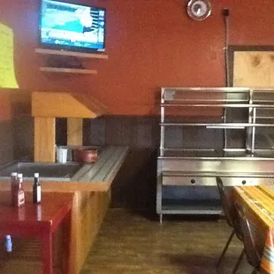 a kitchen and dining area with a flat screen tv