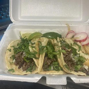 two tacos in a styrofoam container