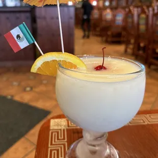 a drink in a glass with an umbrella