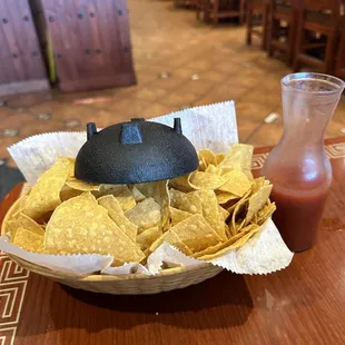 a bowl of chips and a drink
