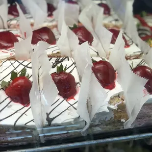 a tray of desserts with strawberries