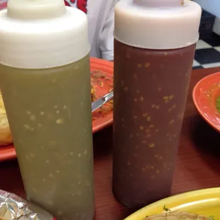 Their hot sauces. Green is mild. Red is HOT